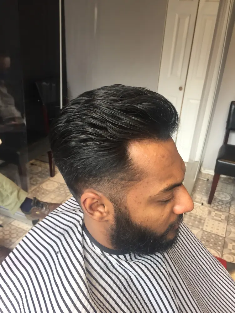 Clean tapered haircut at the pegboard styling station